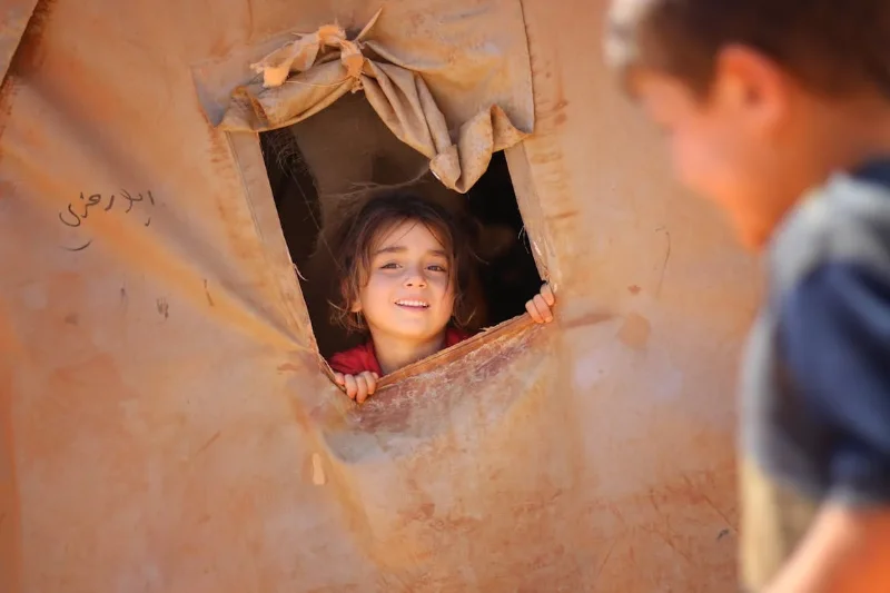 A hungry child living in a tent